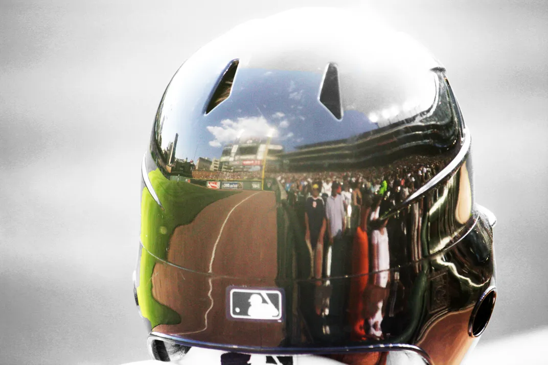 a reflection of a baseball field is seen on a baseball players helment