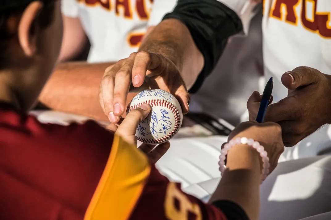 a baseball is being autographed