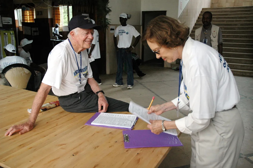 Jimmy and Rosalynn prepare for poll closing procedures during elections in Monrovia, Liberia, on October 11, 2005.