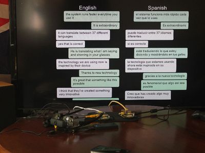 The translated conversation is displayed on a monitor.