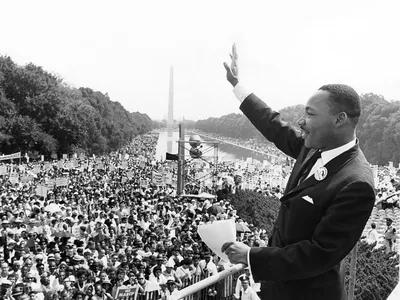 In 1963, standing in front of the Lincoln Memorial, Dr. Martin Luther King, Jr. waves to the largest crowd ever to participate in a civil rights demonstration in Washington, D.C. where he delivered his historic &quot;I Have a Dream&quot; speech.