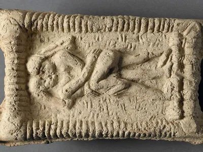A Babylonian clay model dated to 1800 B.C.E. shows a nude couple on a couch engaged in sex and kissing.