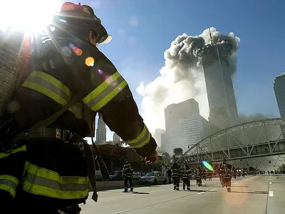 Firefighters walk towards one of the towers at the World Trade Center before it collapsed on September 11, 2001.