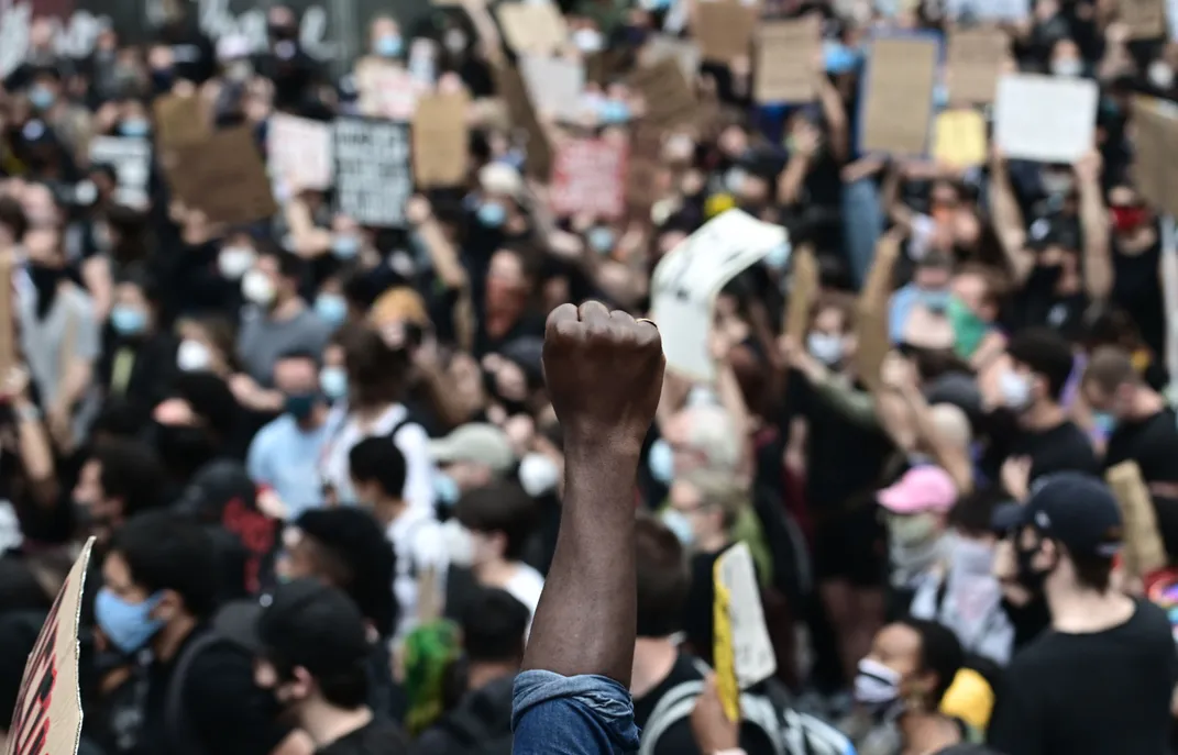 Man raises fist at Black Lives Matter protest