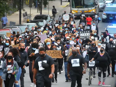 In Boston's Mattapan on August 15, 2020, protesters march from Jubilee Christian Church to protest police brutality, systemic racism and other oppressive systems unfavorable to Black and Brown people.