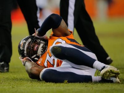 Denver Bronco player David Bruton grabs his head on the field after a reported concussion. Many patients with such head injuries suffer symptoms months after their diagnosis, even though their brains look healthy on CT scans.