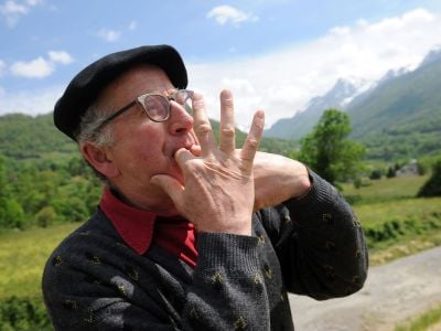A man in Laruns, southwestern France, whistling as a form of speech. Like others in the Canary Islands and elsewhere, local people have learned to whistle their language to communicate across long distances. Linguists are studying whistled speech to help understand which sound elements are essential to comprehension.