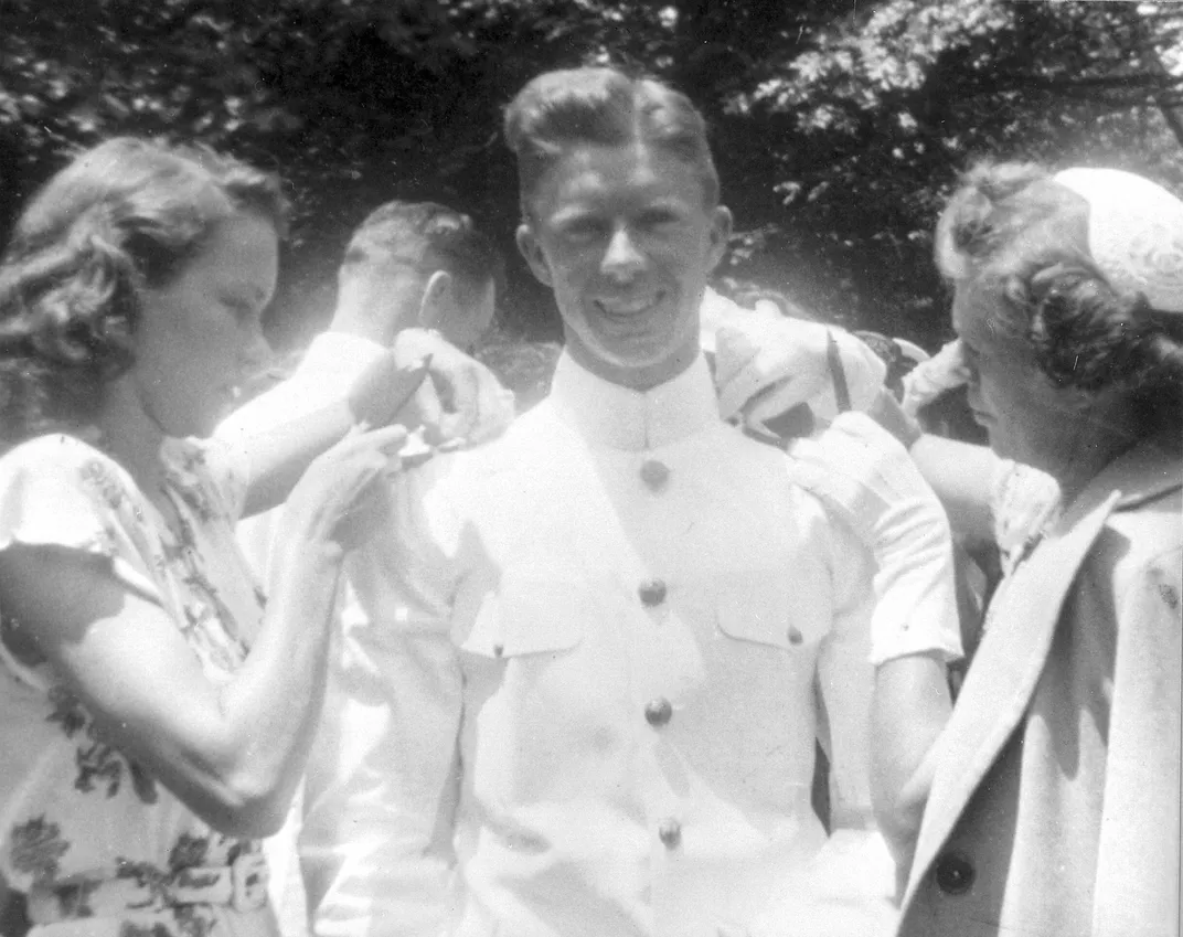 Rosalynn pins ensign bars onto Jimmy's uniform ahead of his graduation from the U.S. Naval Academy in 1946.