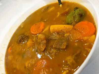 Soup joumou is a savory, orange-tinted soup that typically consists of calabaza squash, beef, noodles, carrots, cabbage, various other vegetables and fresh herbs and spices.