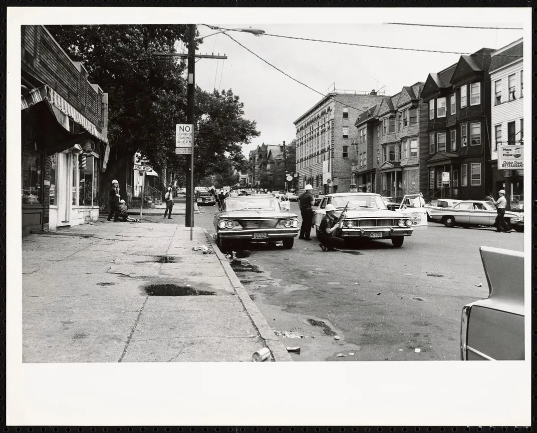 Police patrol the streets during the 1967 Newark Riots