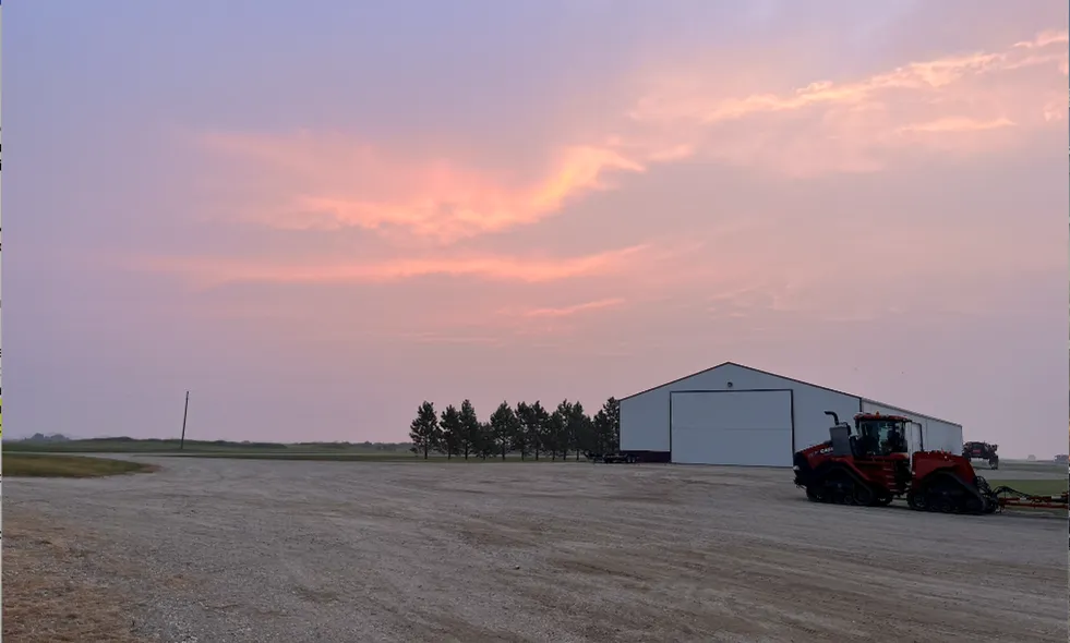 Sunrise over a farm shed in North Dakota.